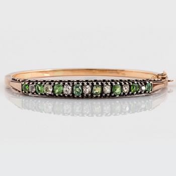 A pair of 14K gold and silver bangles set with demantoid garnets and old-cut diamonds.