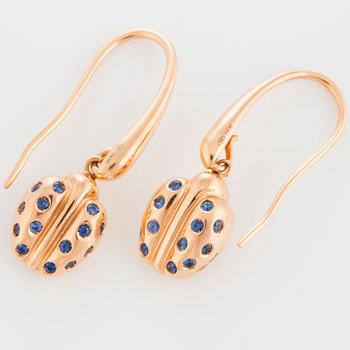 A pair of Faraone earrings in 18K gold set with faceted sapphires.