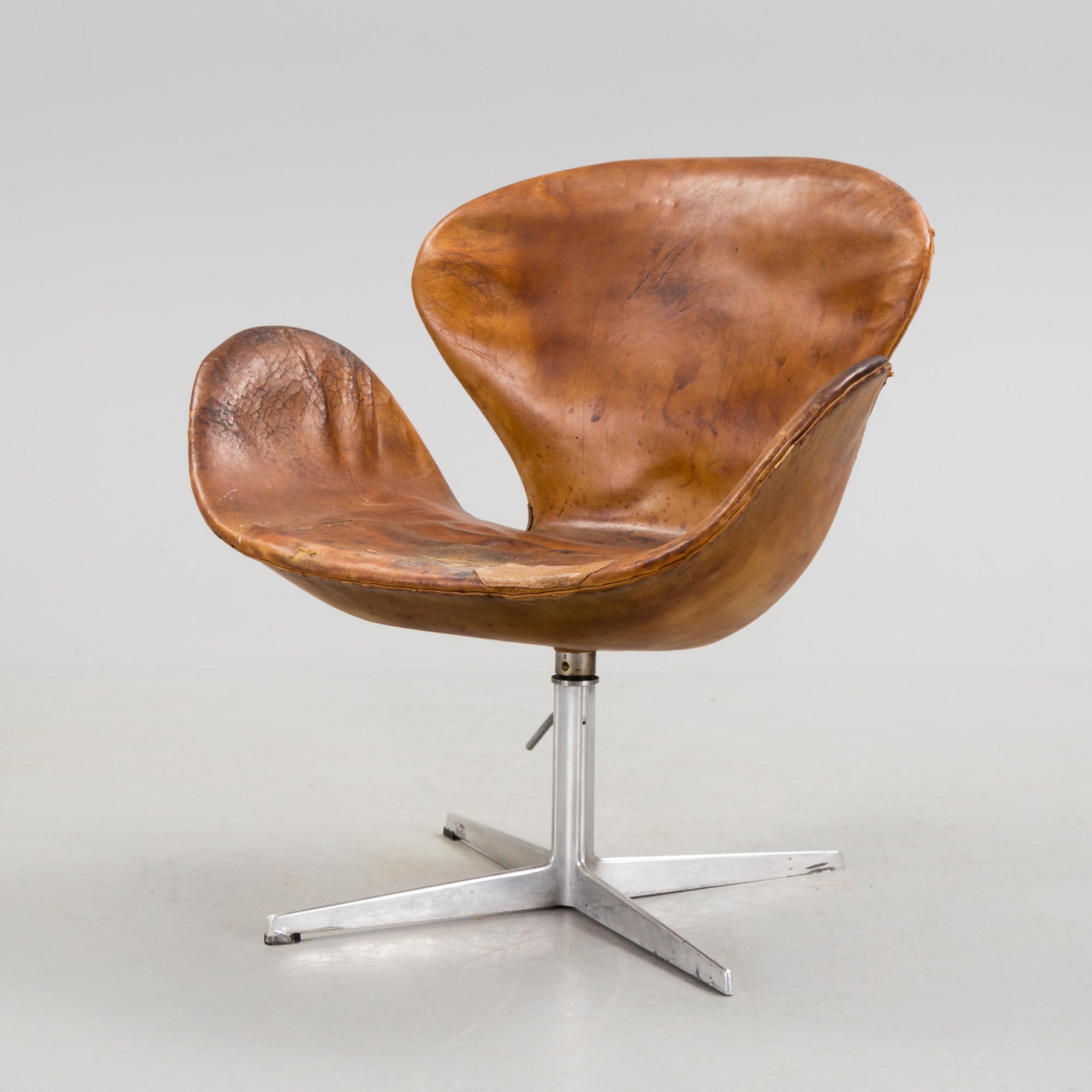 An Arne Jacobsen steel and brown leather 'Swan' chair, Fritz Hansen, Denmark 1960's.