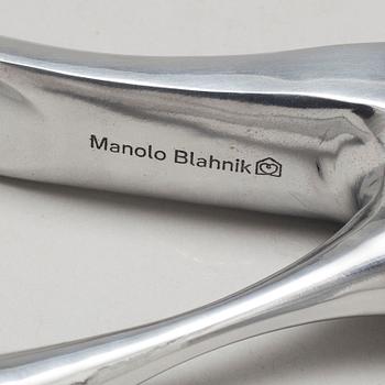 A metal shoe horn by Manolo Blahnik, with orignal box.