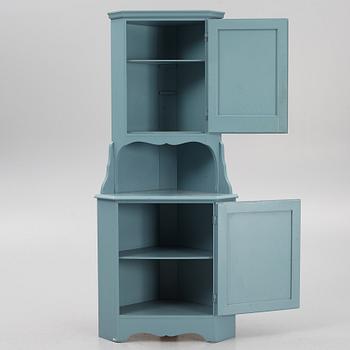 A corner cabinet, 20th century.