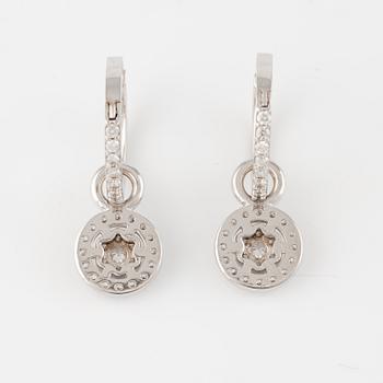 A pair of 18K gold earrings with round brilliant-cut diamonds.