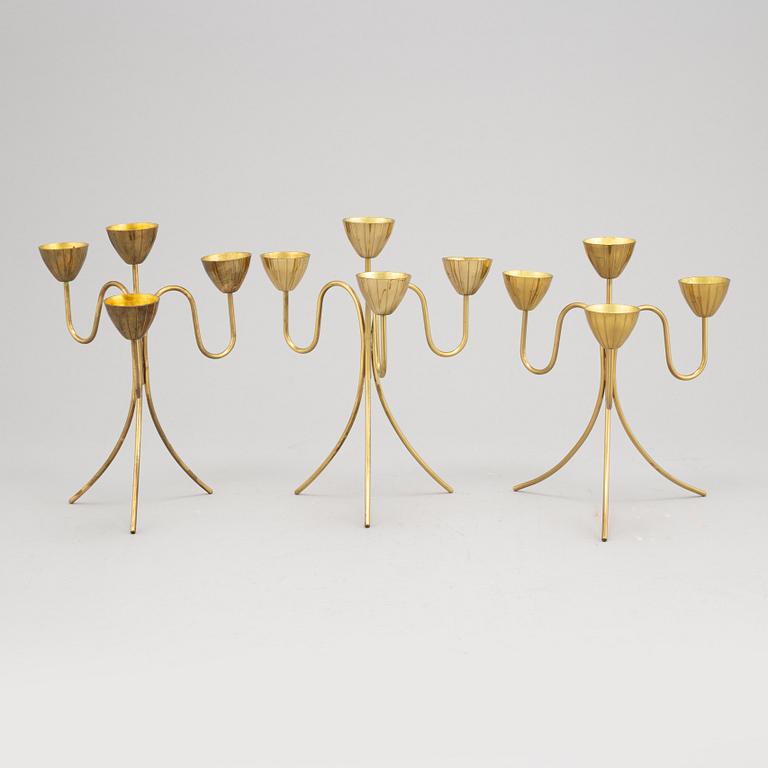 Gunnar Ander, a set of three brass five-light candelabra from Ystad Metall.