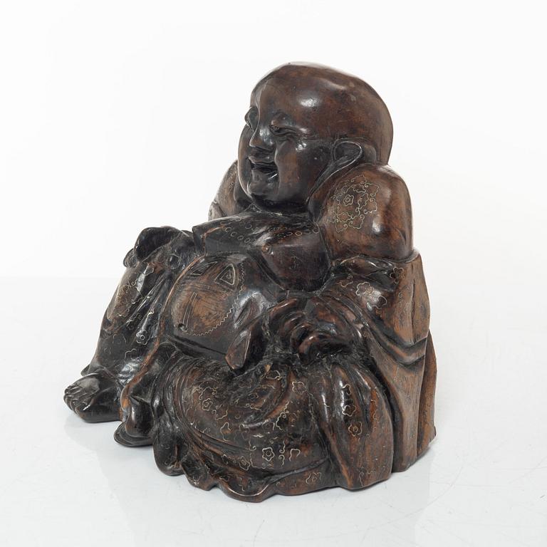 A Chinese wooden figure of Budai with silver inlays, Qing dynasty (1644-1912).