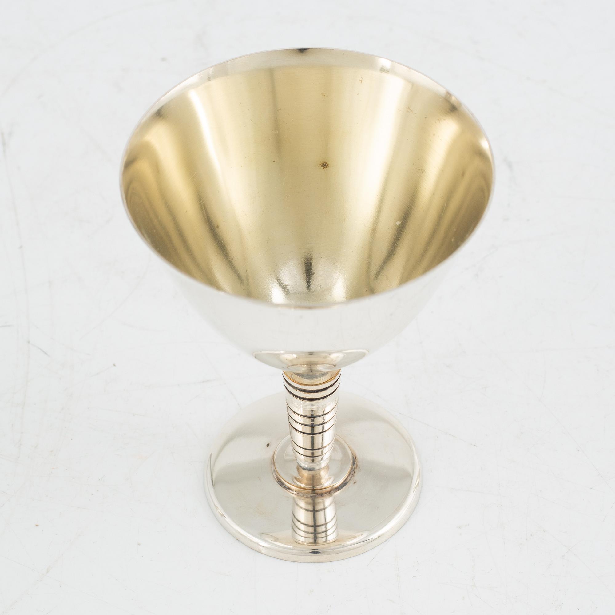 Folke Arström, eight silver plate cocktail glasses and a shaker, GAB.