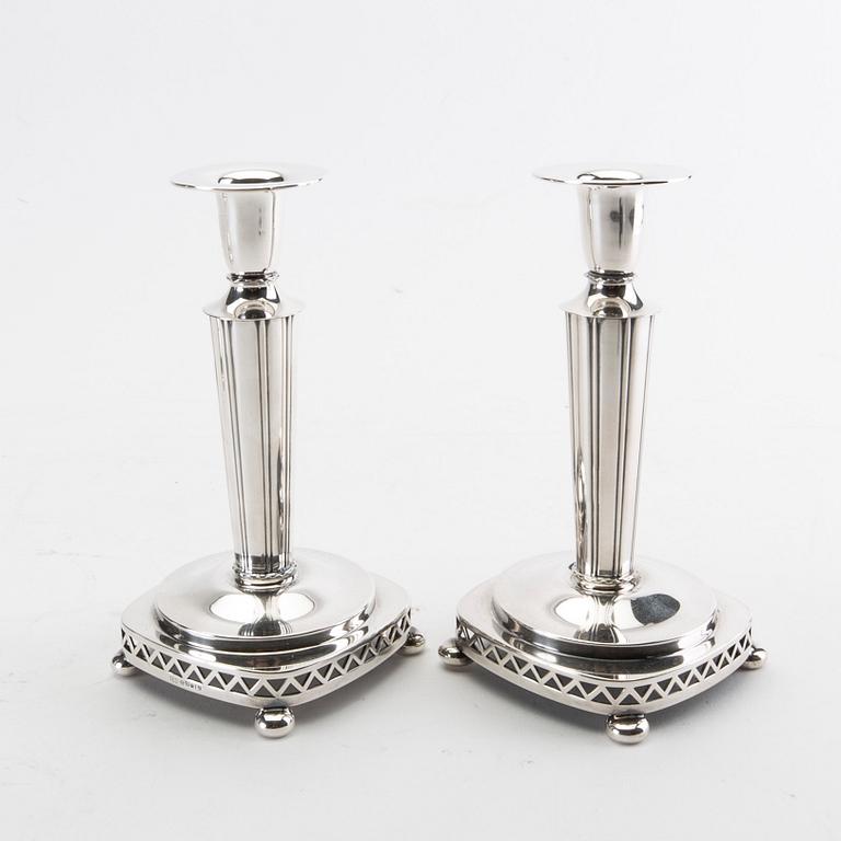 Two pairs of silver candle sticks from 1956 and 1992.