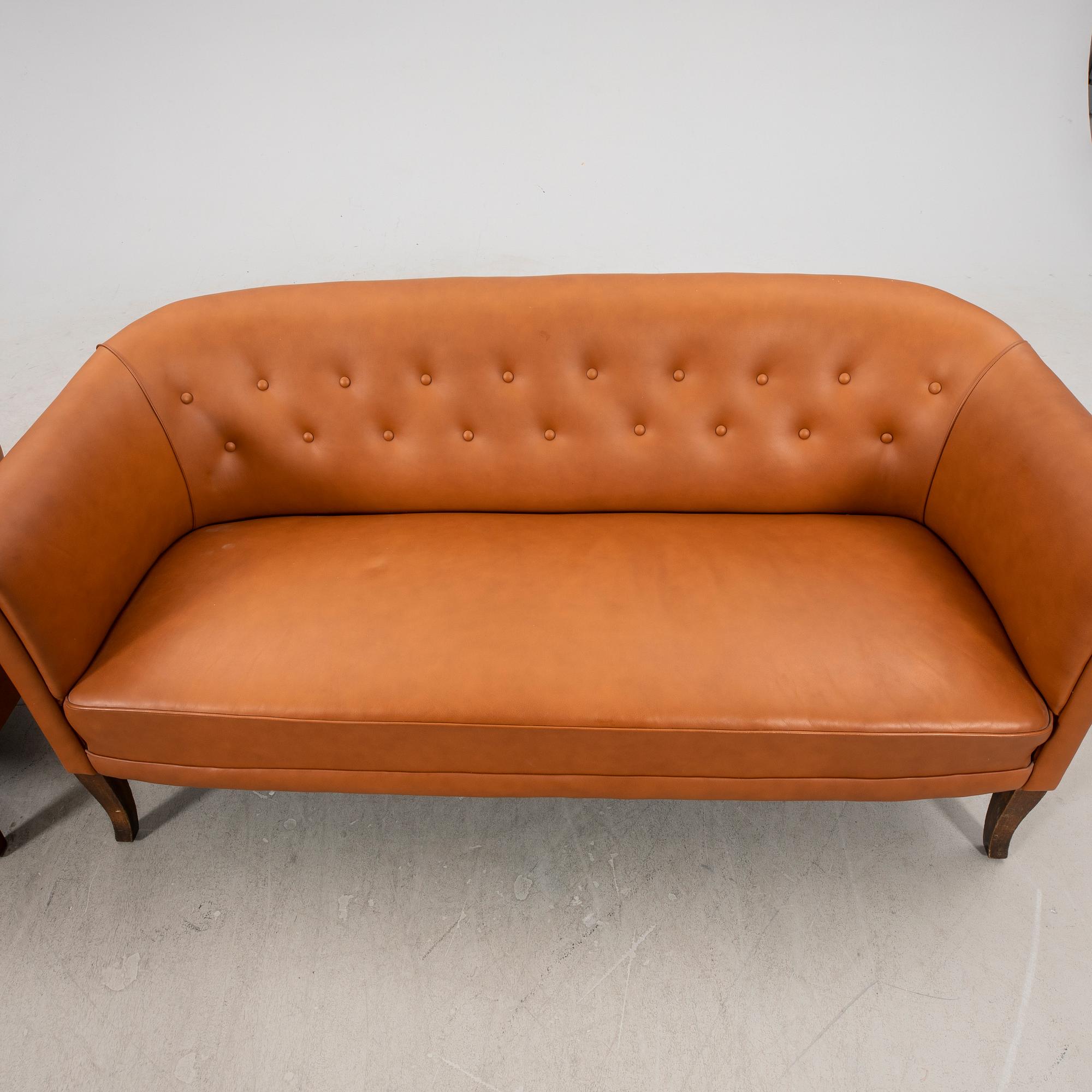 A leather sofa and armchair 1940s.