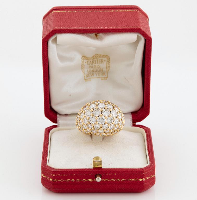 Cartier "Marrakech" an 18K gold bombé ring set with round brilliant-cut diamonds.