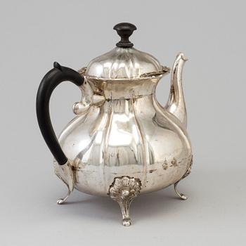 A silver rococo style teapot.