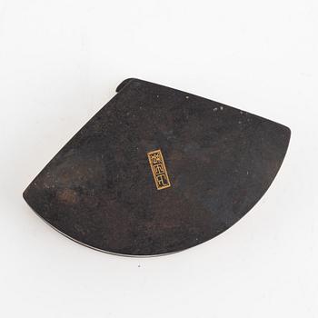 A Japanese gilt-bronze fan-shaped box and gilt iron tsuba with mei inscription, Meiji period (1868-1912).