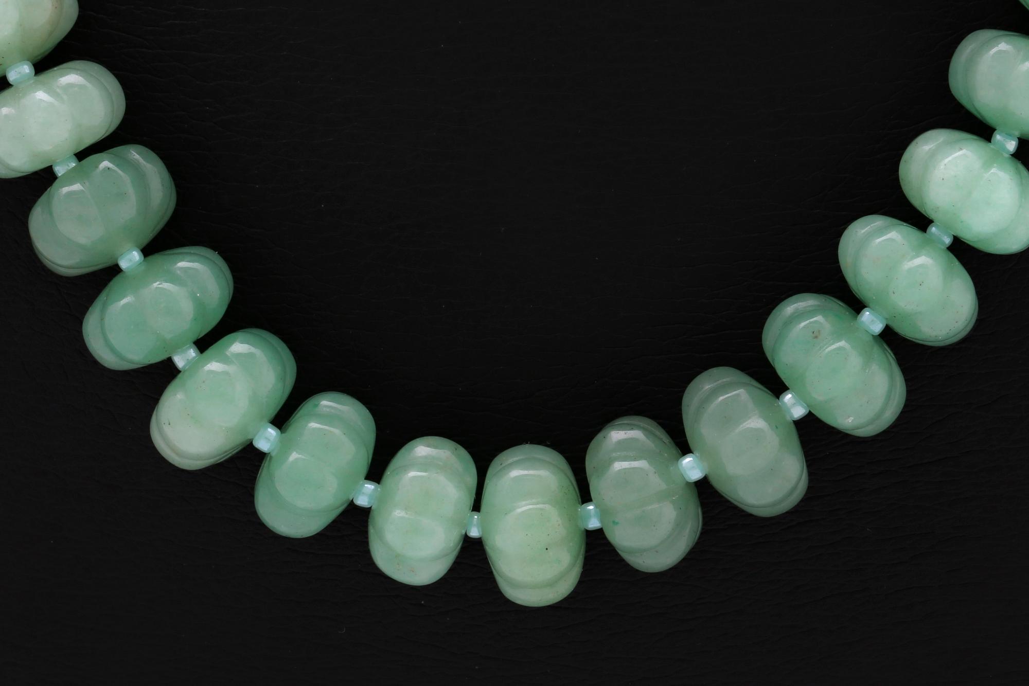Necklace carved jade beads approx 15 mm and smaller glass beads , clasp metal, approx 50 cm.