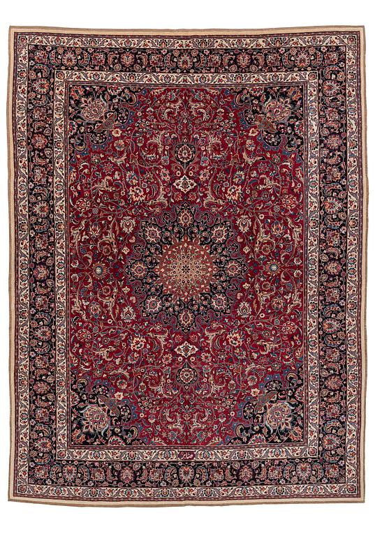 A semi-antique Mashad carpet, signed Saber, c. 401 x 300 cm.