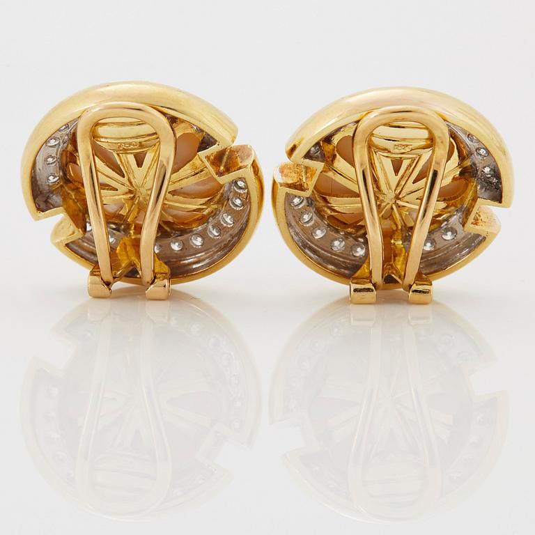 A pair of 18K gold and mabe pearl earrings set with round brilliant-cut diamonds.