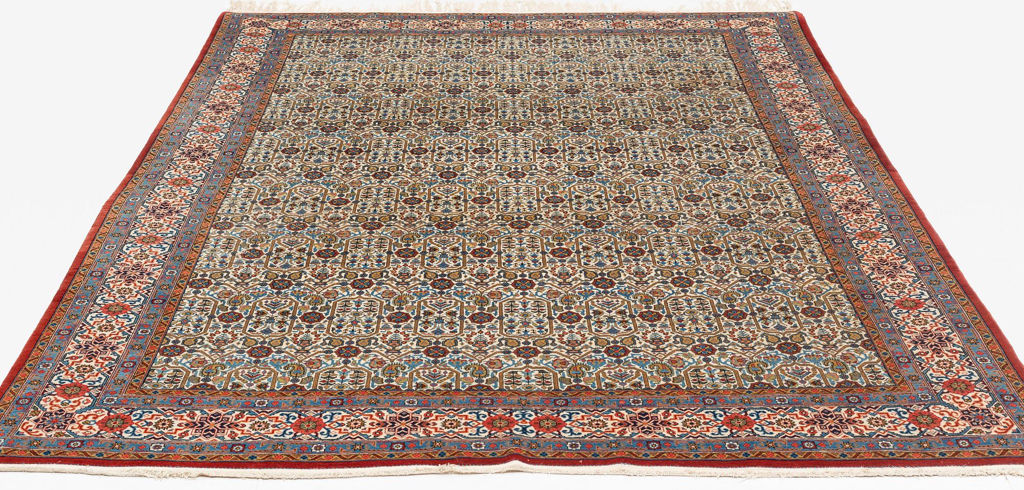 A carpet, semi-antique, Qum, ca 324 x 221 cm.