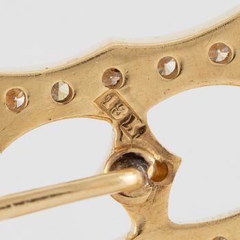 Kravattnål, i form av "H", 18K guld med briljantslipade diamanter.
