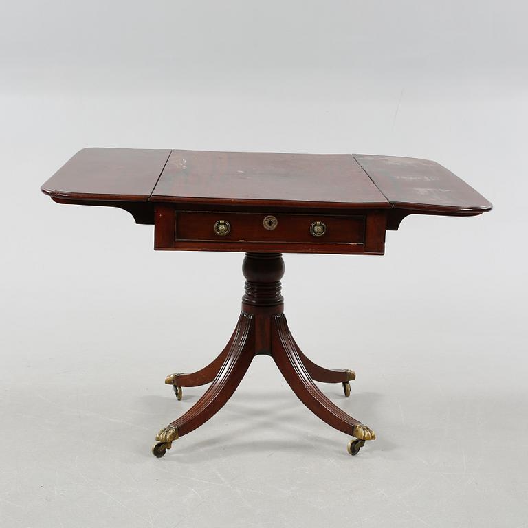 A drop-leaf table, English style, late 19th century.