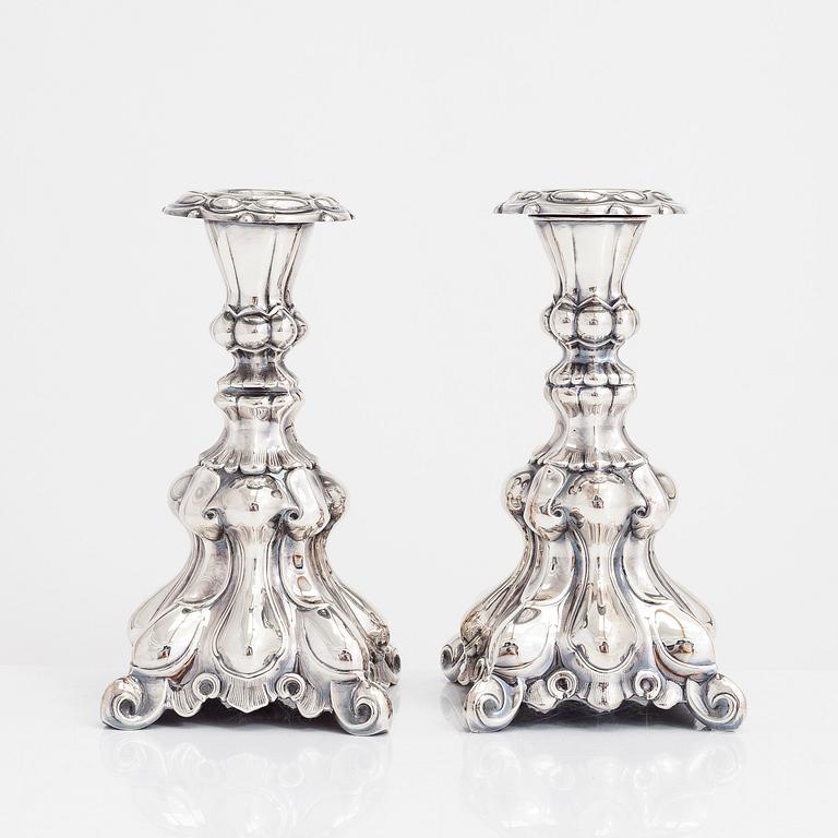 Two similar baroque style silver candlesticks by Kultakeskus, Hämeenlinna 1948 and Hopeatehdas Oy, Helsinki 1953.