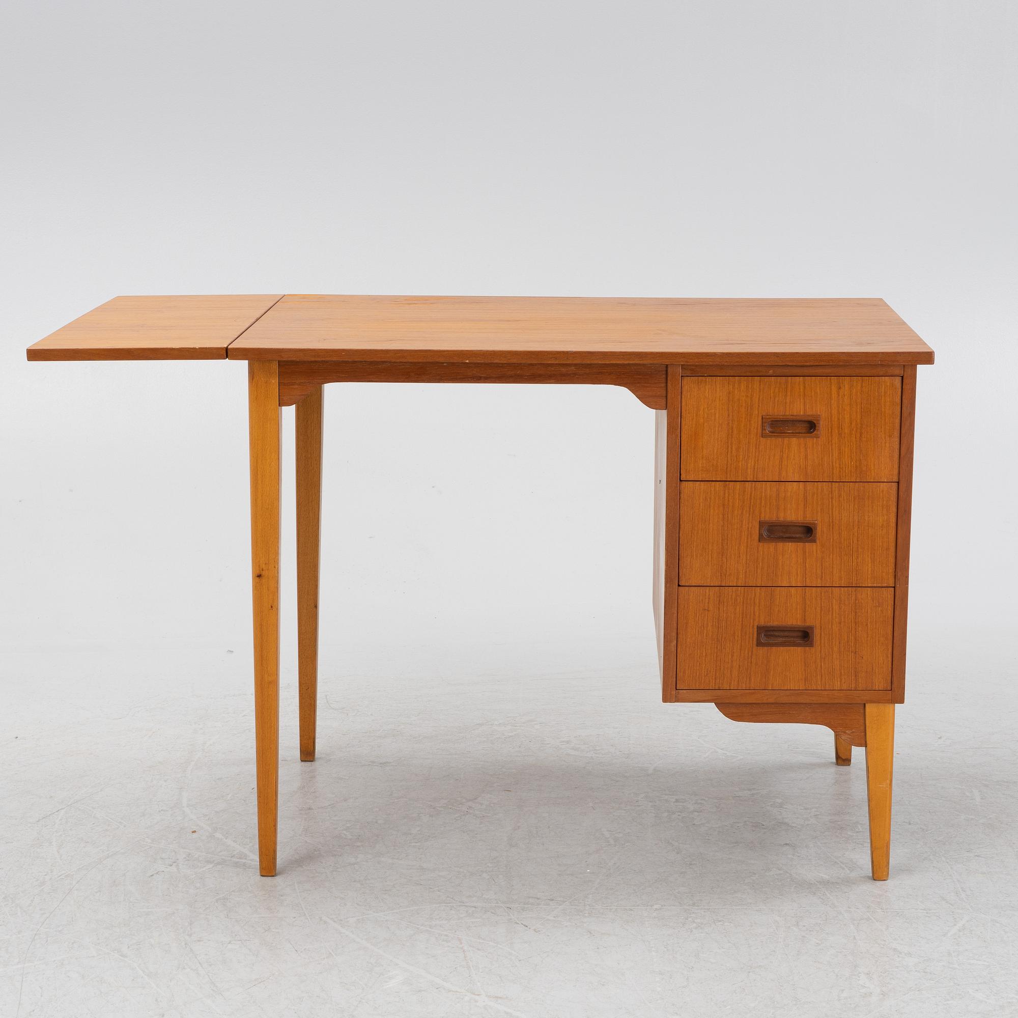A teak veneered desk, mid 20th Century.