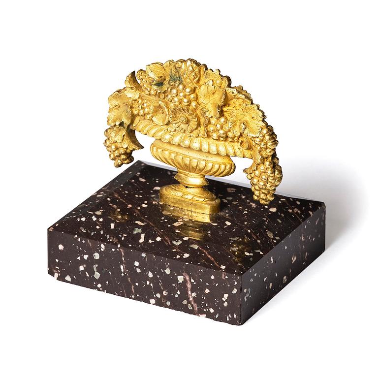 An Empire 'Loka-Risberg'-porhyry and ormolu paperweight, Älvdalen, early 19th century.