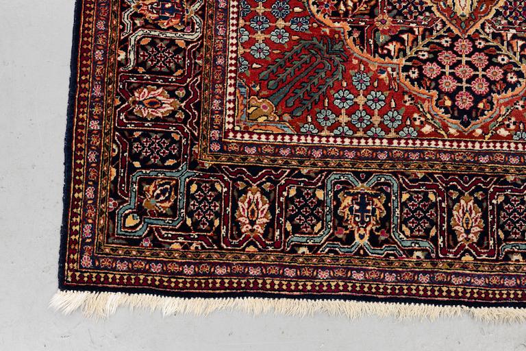 A rug, semi-antique Kashan, ca 216,5 x 140 cm.