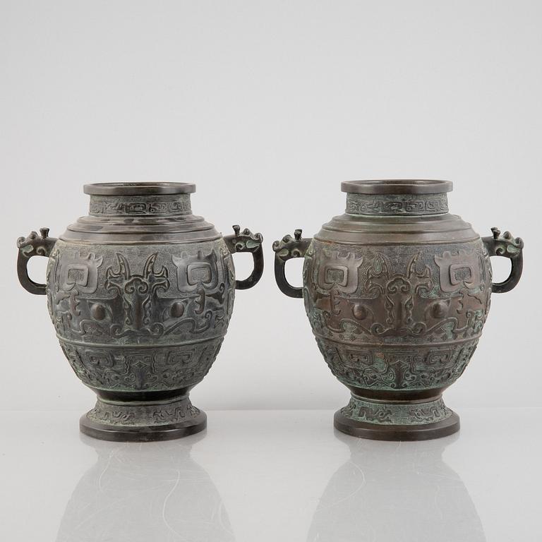 A pair of Chinese bronze urns, 20th century.