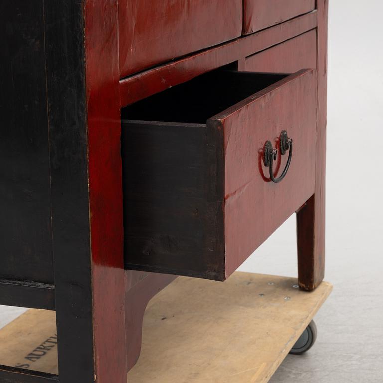 A red-lacquered cabinet, China, 20th century.