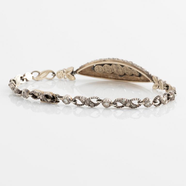 A silver bracelet with rose-cut diamonds.