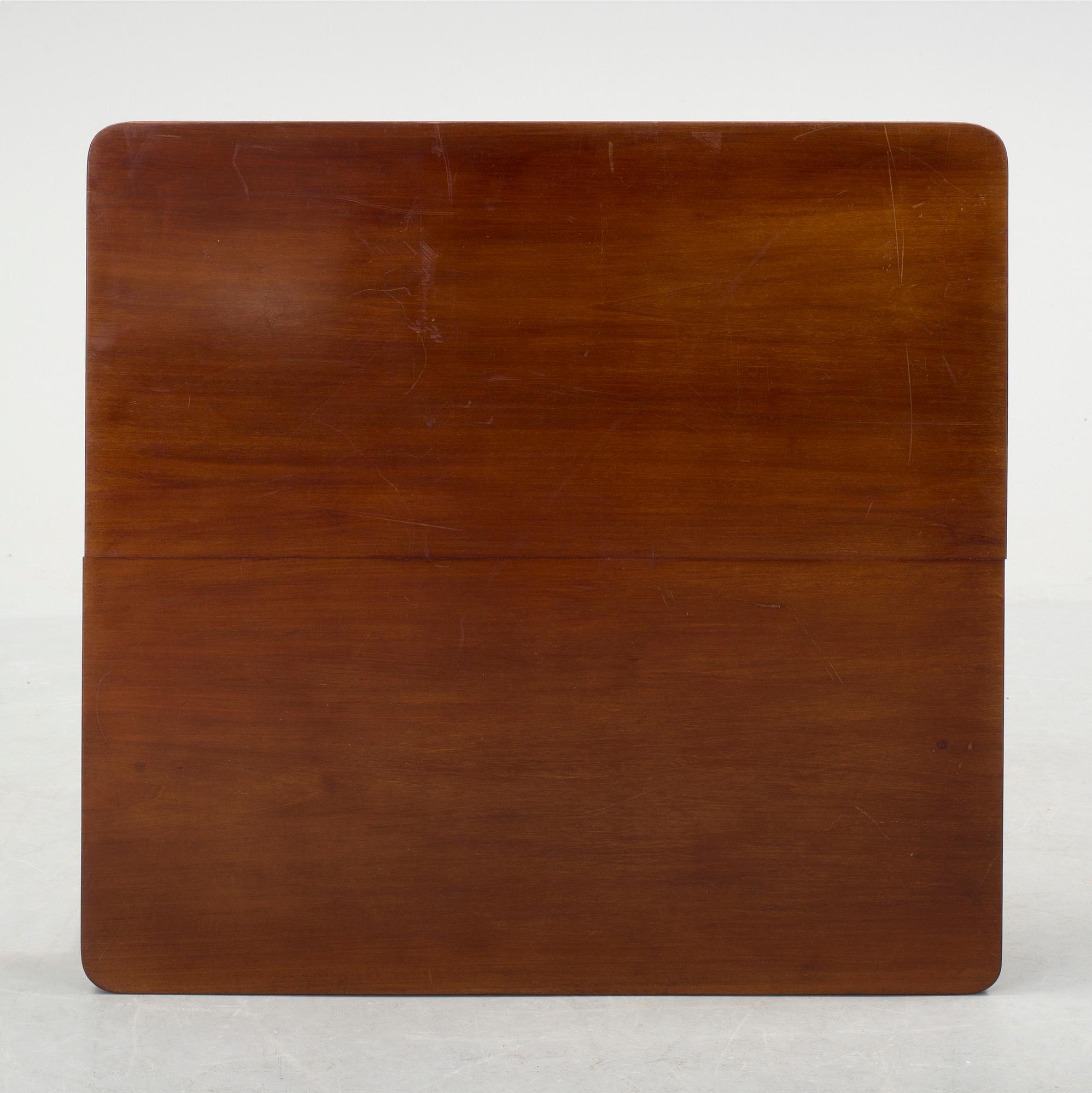 A mid 20th century mahogany veneered table from Nordiska Kompaniet (NK).