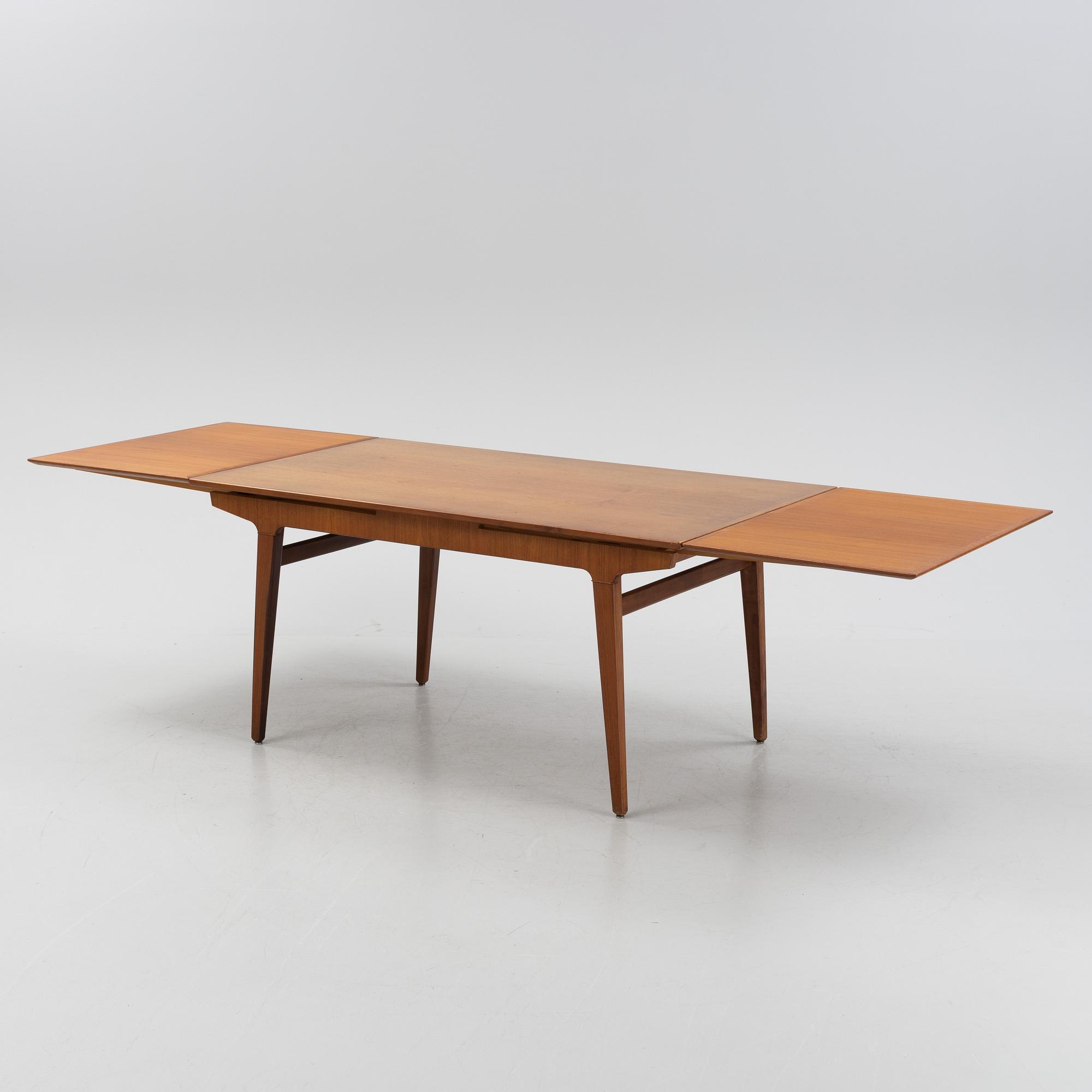 A 1960s teak veneer dining table.