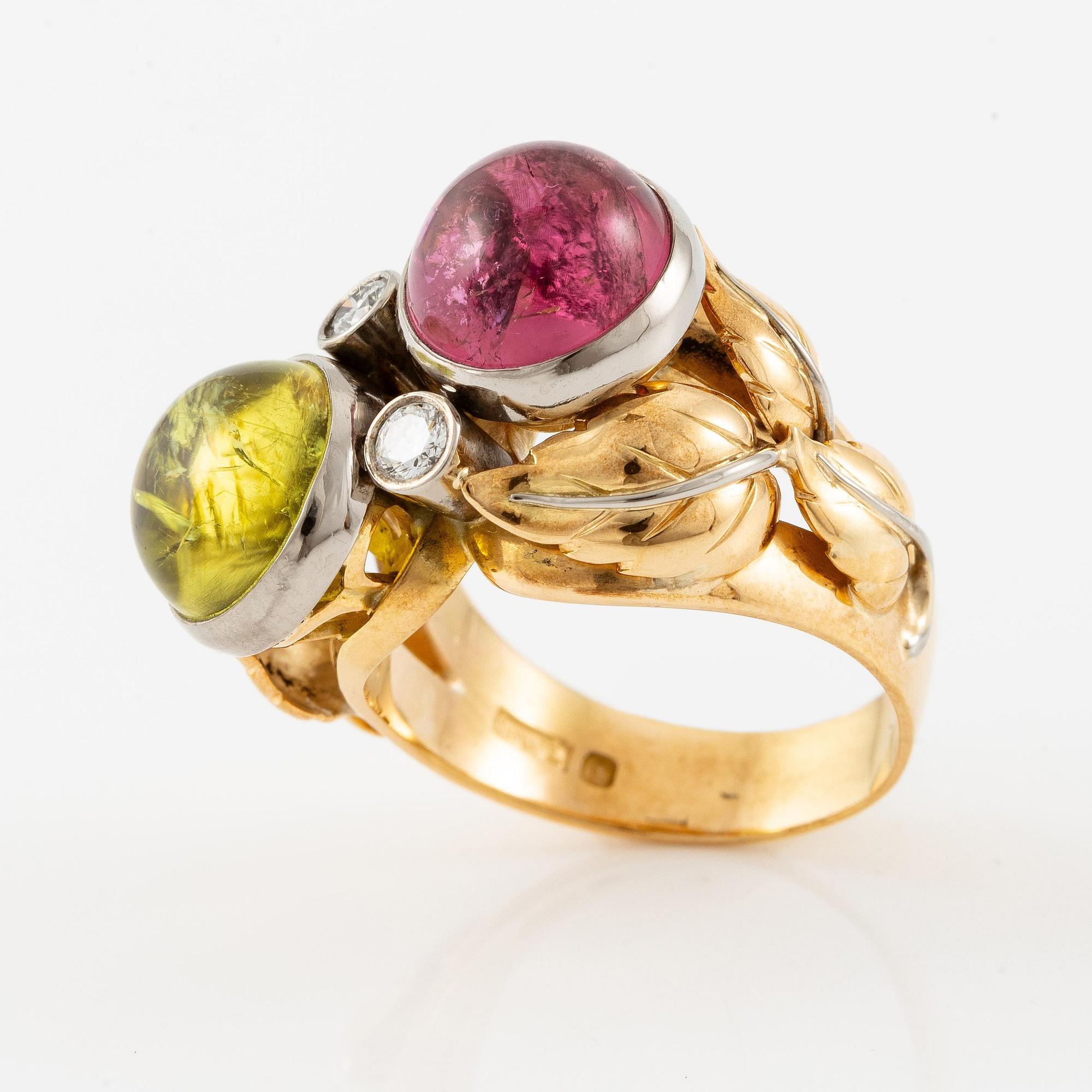 An 18K gold ring with cabochon-cut tourmalines.