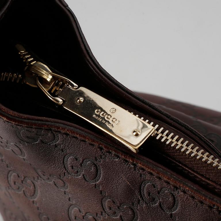 Gucci, a leather bag.