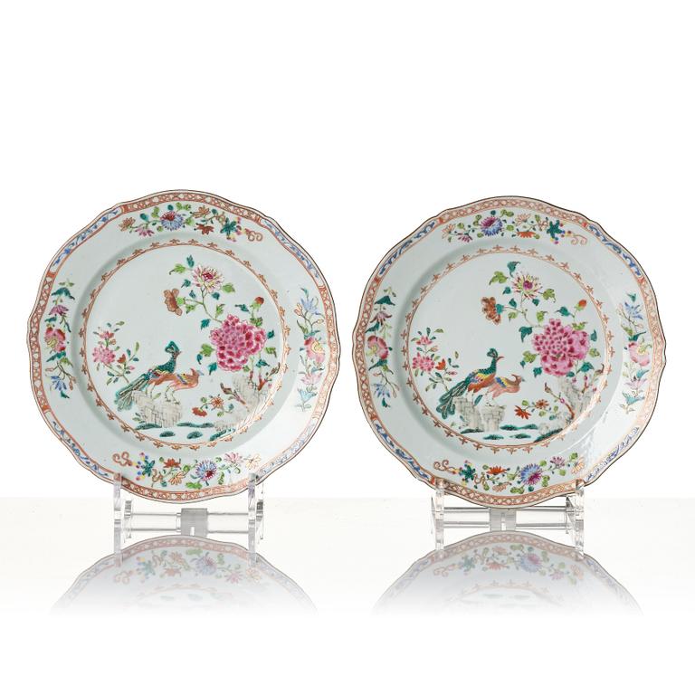 A pair of Chinese famille rose porcelain 'double peacock' plates, Qing dynasty, Qianlong (1736-95).