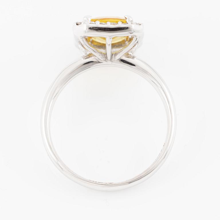 Ring 18K guld med en fasettslipad safir och runda briljantslipade diamanter.