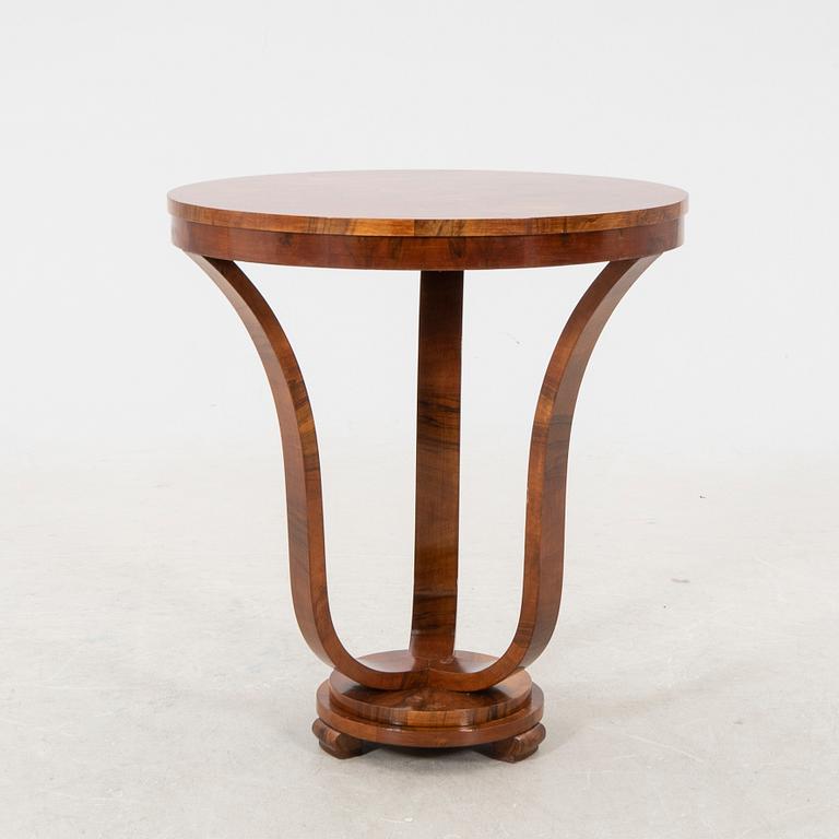 A stained walnut table from the first half of the 20th century.