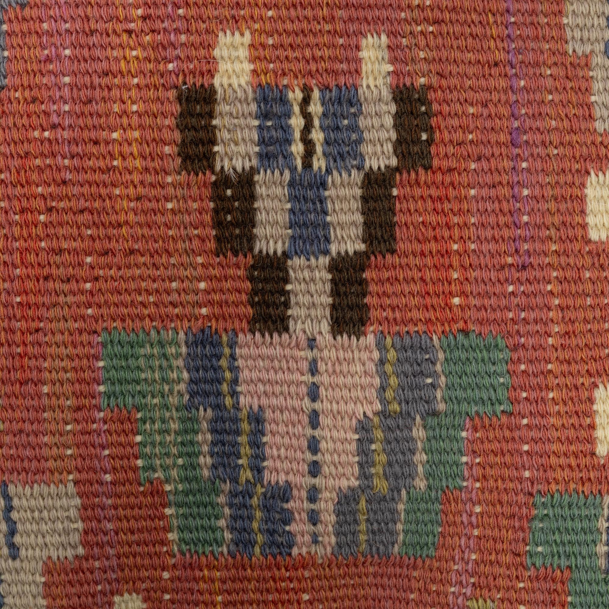 Märta Måås-Fjetterström, a cushion, 'Blommor på röd botten', signed AB MMF, ca. 31 x 31 cm.
