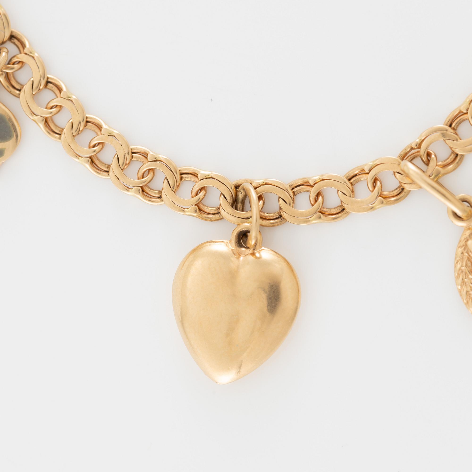 Armband 18K guld med berlocker.