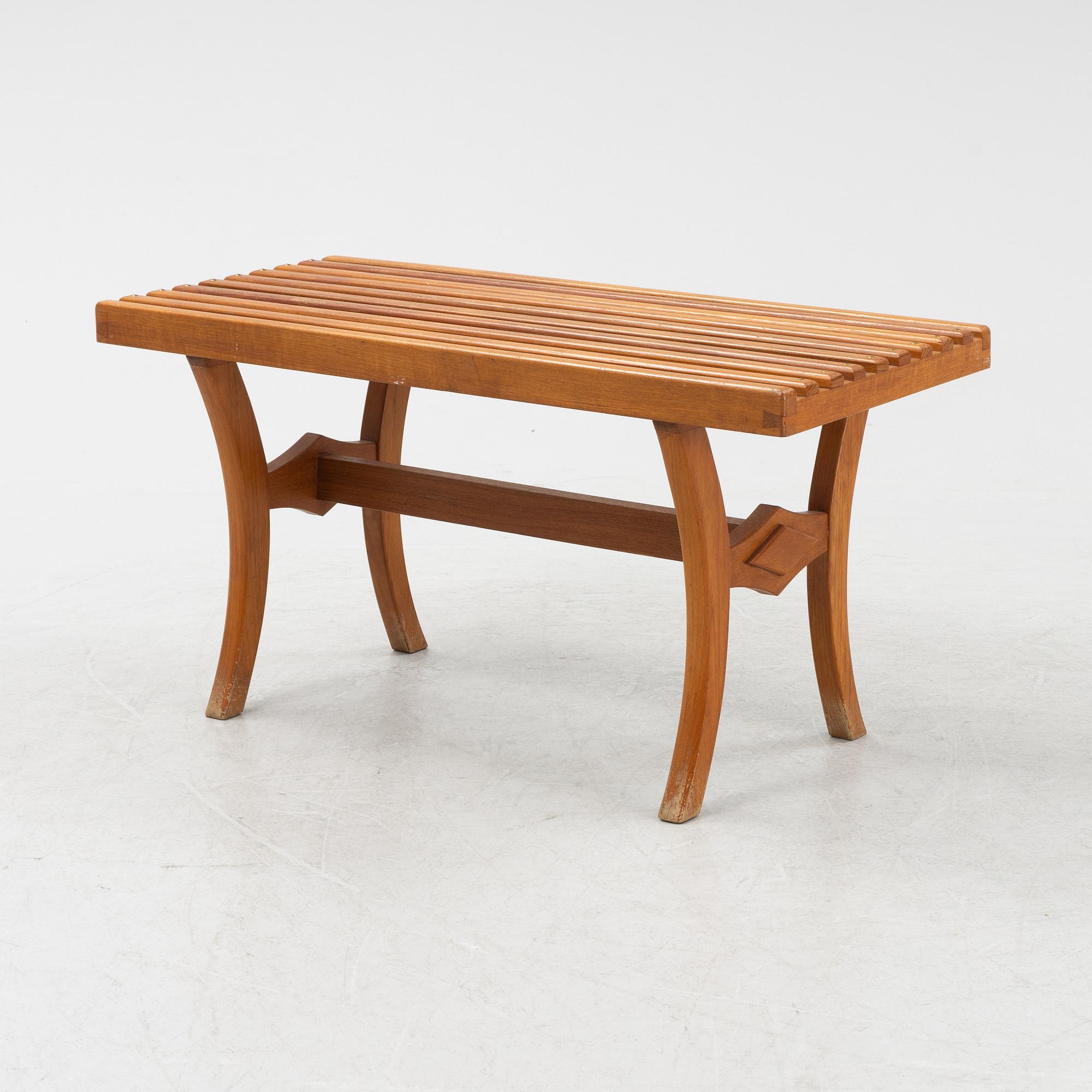 A stained-wood bench, later part of the 20th Century.