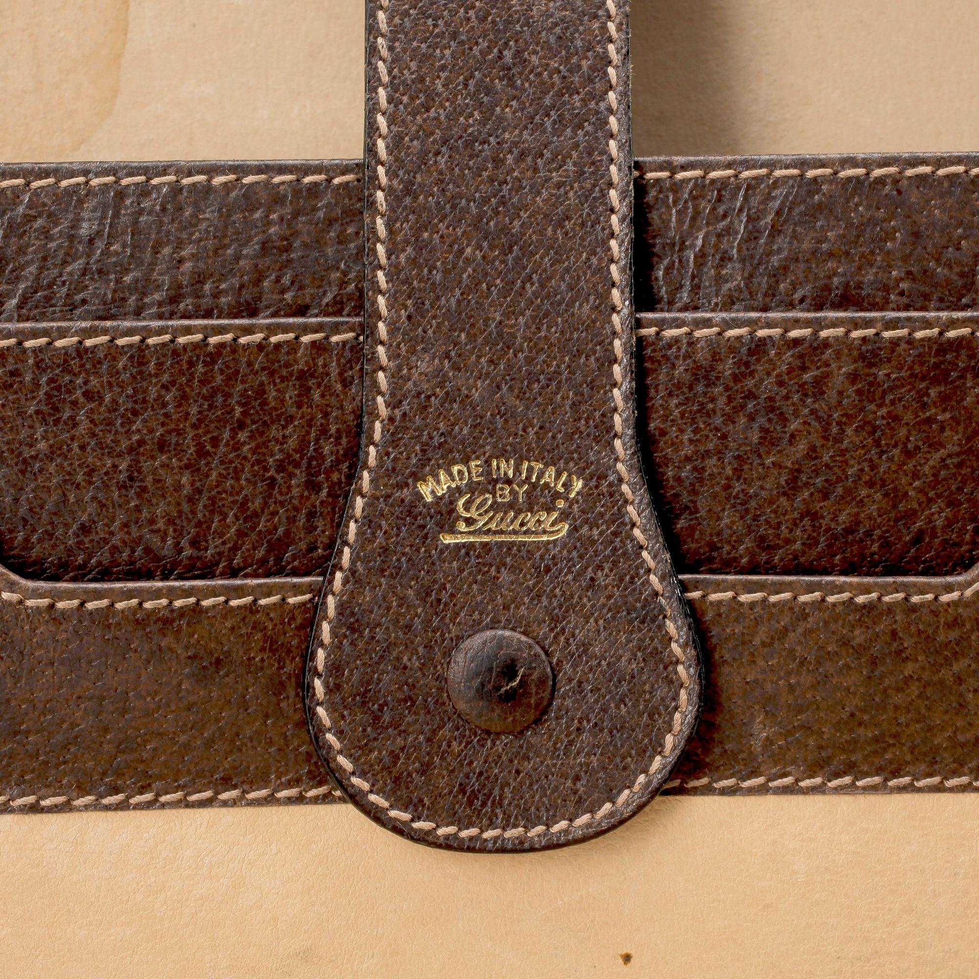 GUCCI, a brown leather briefcase.
