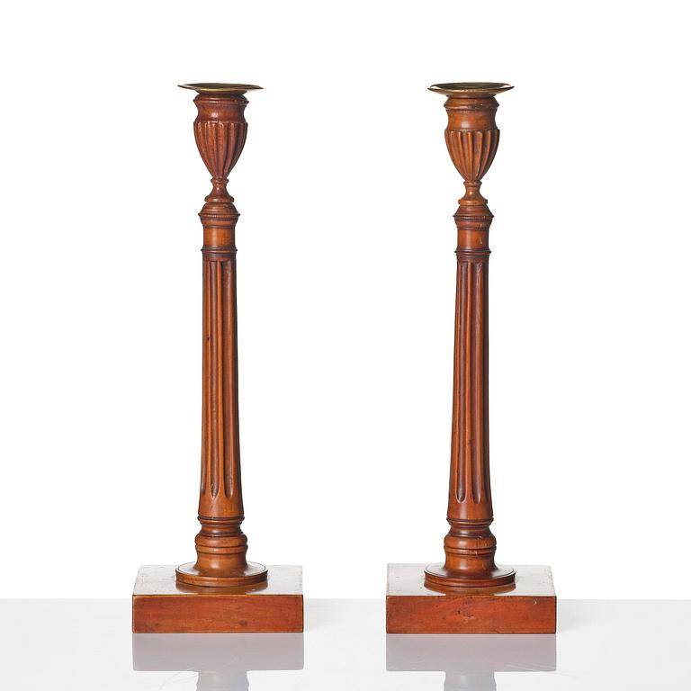 A pair of George III mahogany candlesticks, circa 1800.