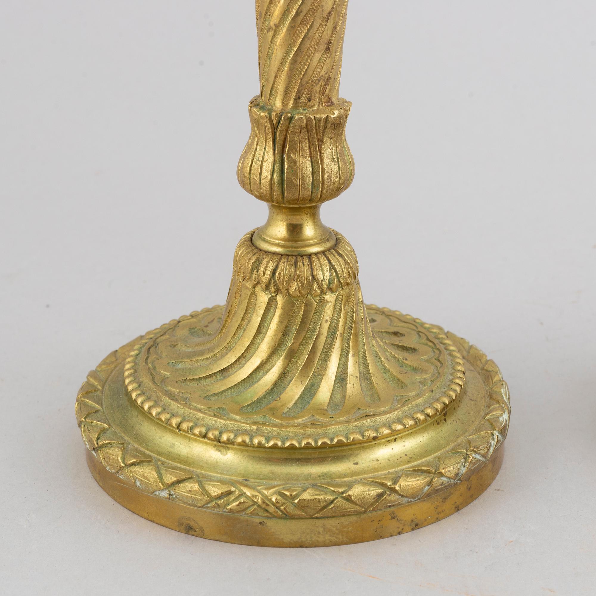 A pair of bronze Louis XV-style candlesticks, circa 1900.