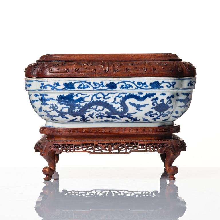 A blue and white quatrefoil dragon box with wooden cover and stand, Ming dynasty, Wanli mark and period (1573-1620).