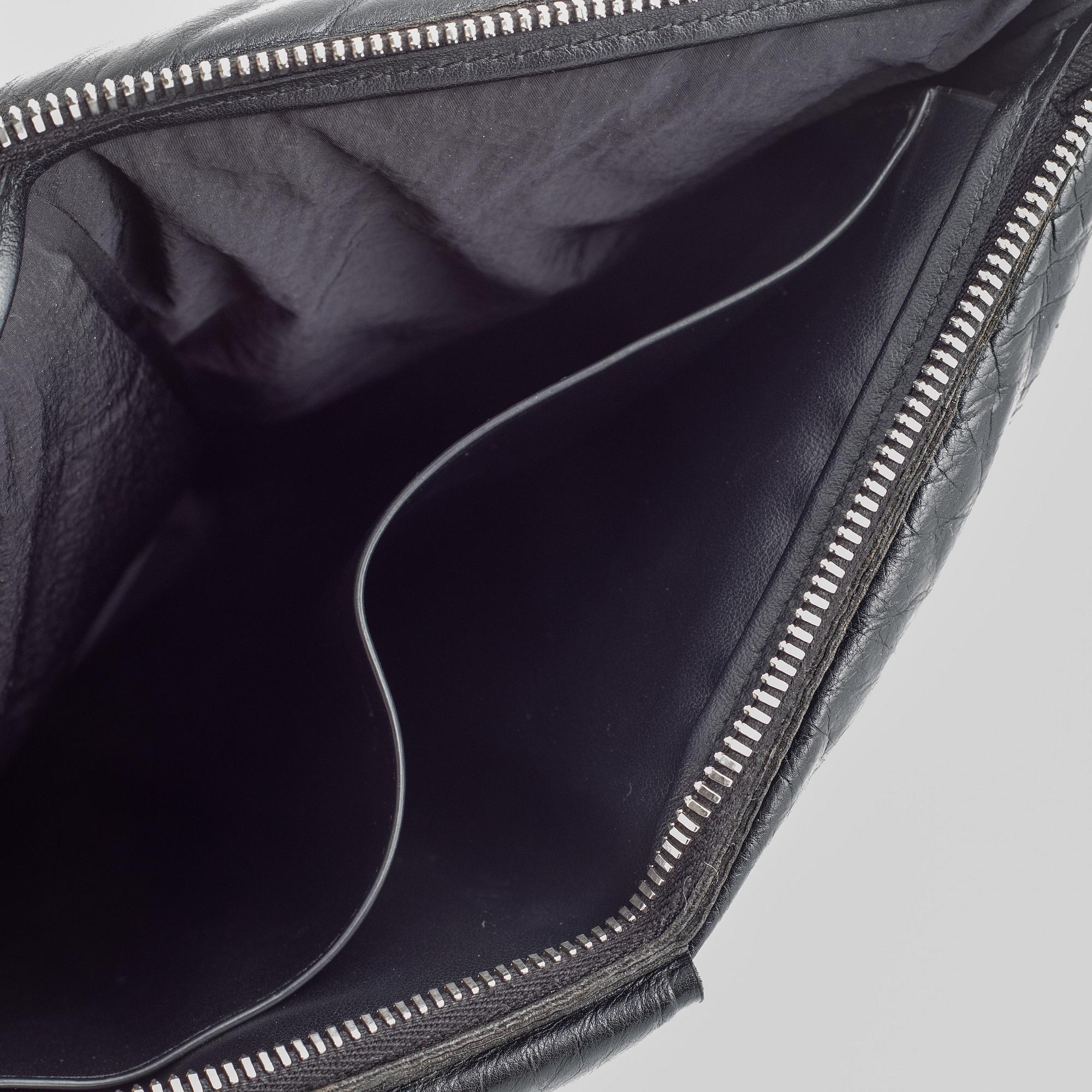 Bottega Veneta, a black leather handbag.