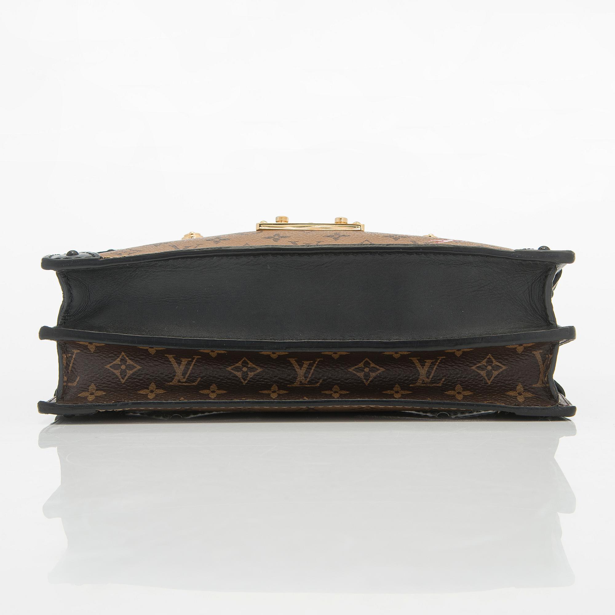 Louis Vuitton, a "Reverse Monogram Trunk Clutch" bag.