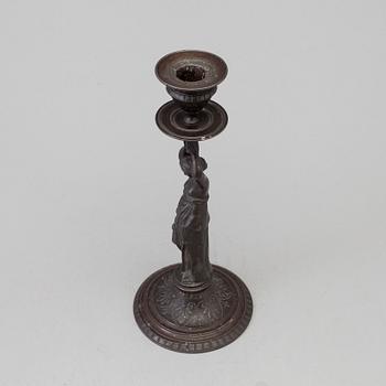 A 19th century iron candlestick marked F.L Vombach Offenbach A/M.