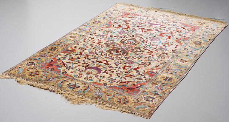 A RUG. An antique silk Kashan so called Motachem. 202,5 x 136,5 cm.