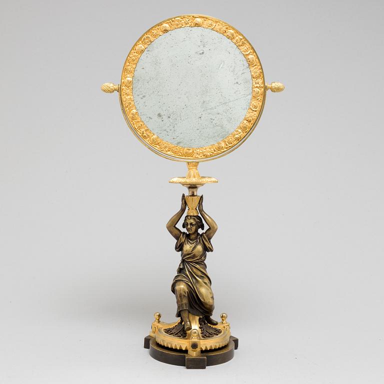 AN EMPIRE ORMOLU TABLE MIRROR, first half of the 19th century.