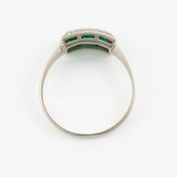 Ring in platinum set with step-cut emeralds and rose-cut diamonds.