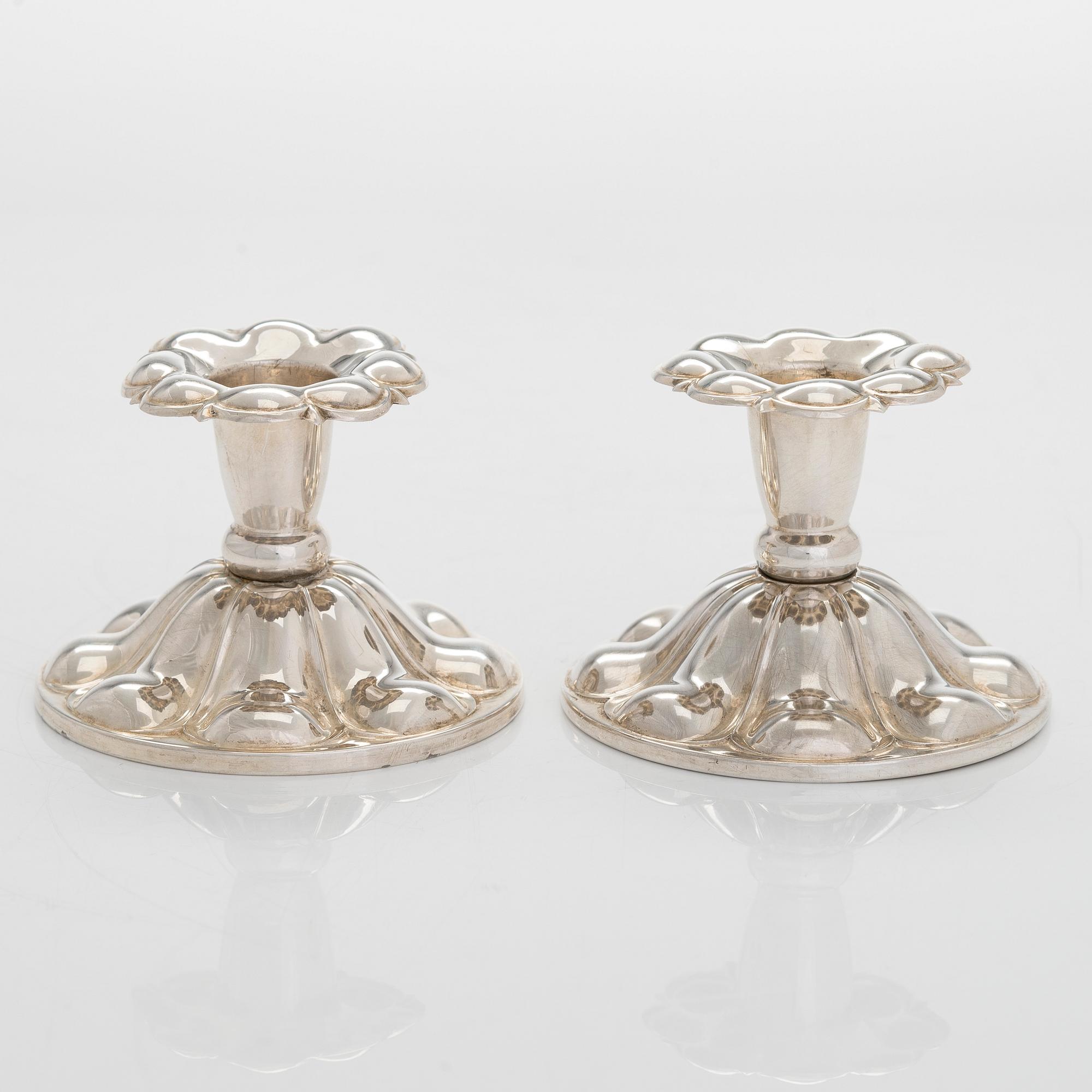 A 47-piece set of 'Chippendale' silver cutlery and a pair of silver candlesticks, Finnish marks 1983-2003 and 1976.