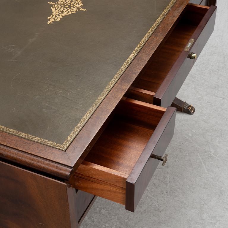 A mahogany veneer desk with desk chair, 20th Century.