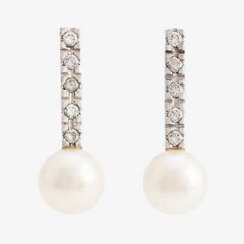 A pair of 18K gold earrings with cultured pearls and round brilliant-cut diamonds.